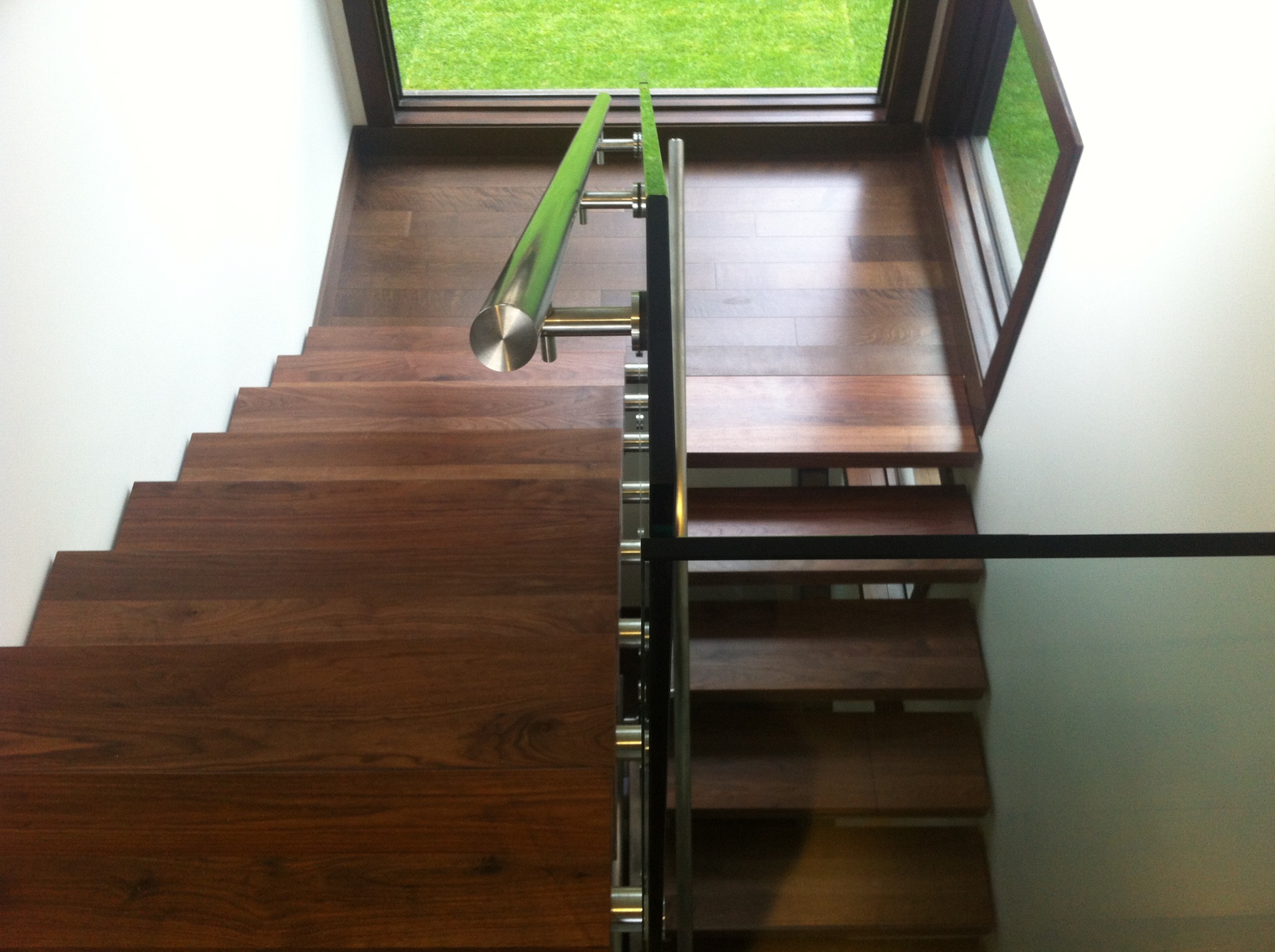 West Vancouver Home — solid Vintage walnut floating stair treads with stainless handrail and glass railing