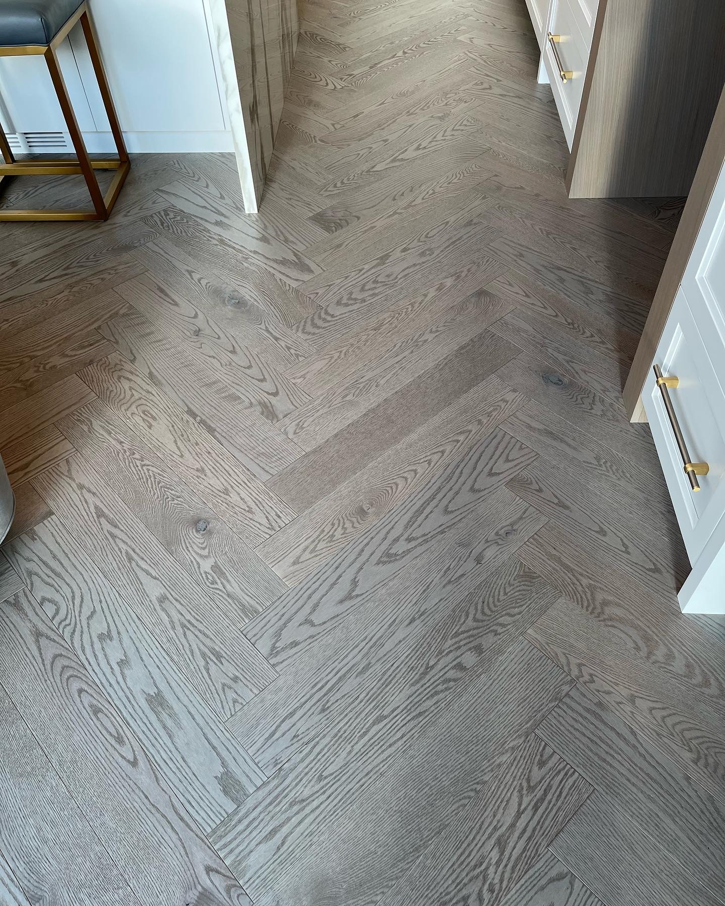 Whistler Home — close-up of Mirage character white oak herringbone flooring