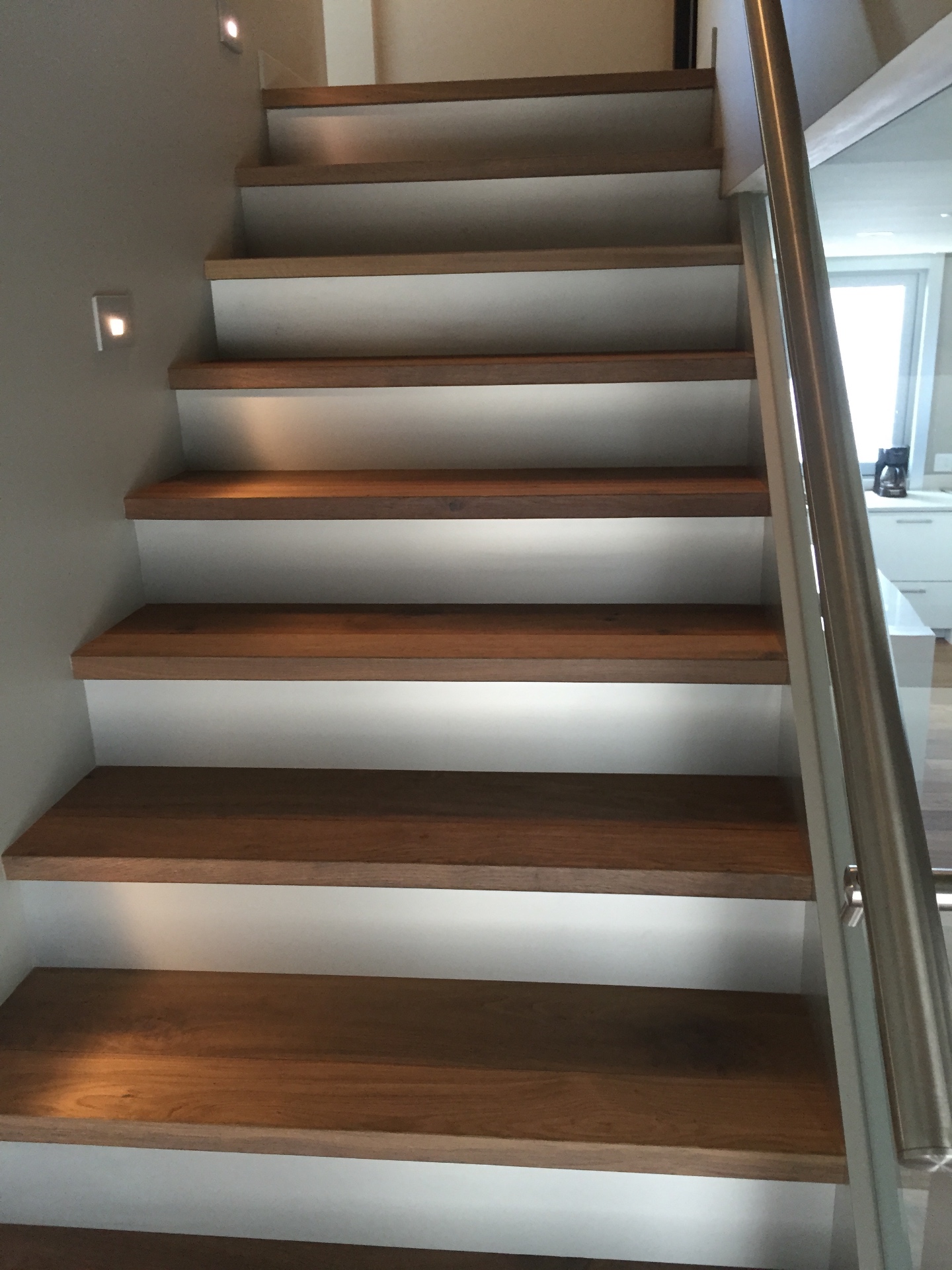 Gibsons House — solid white oak stair treads with floating risers and LED step lights