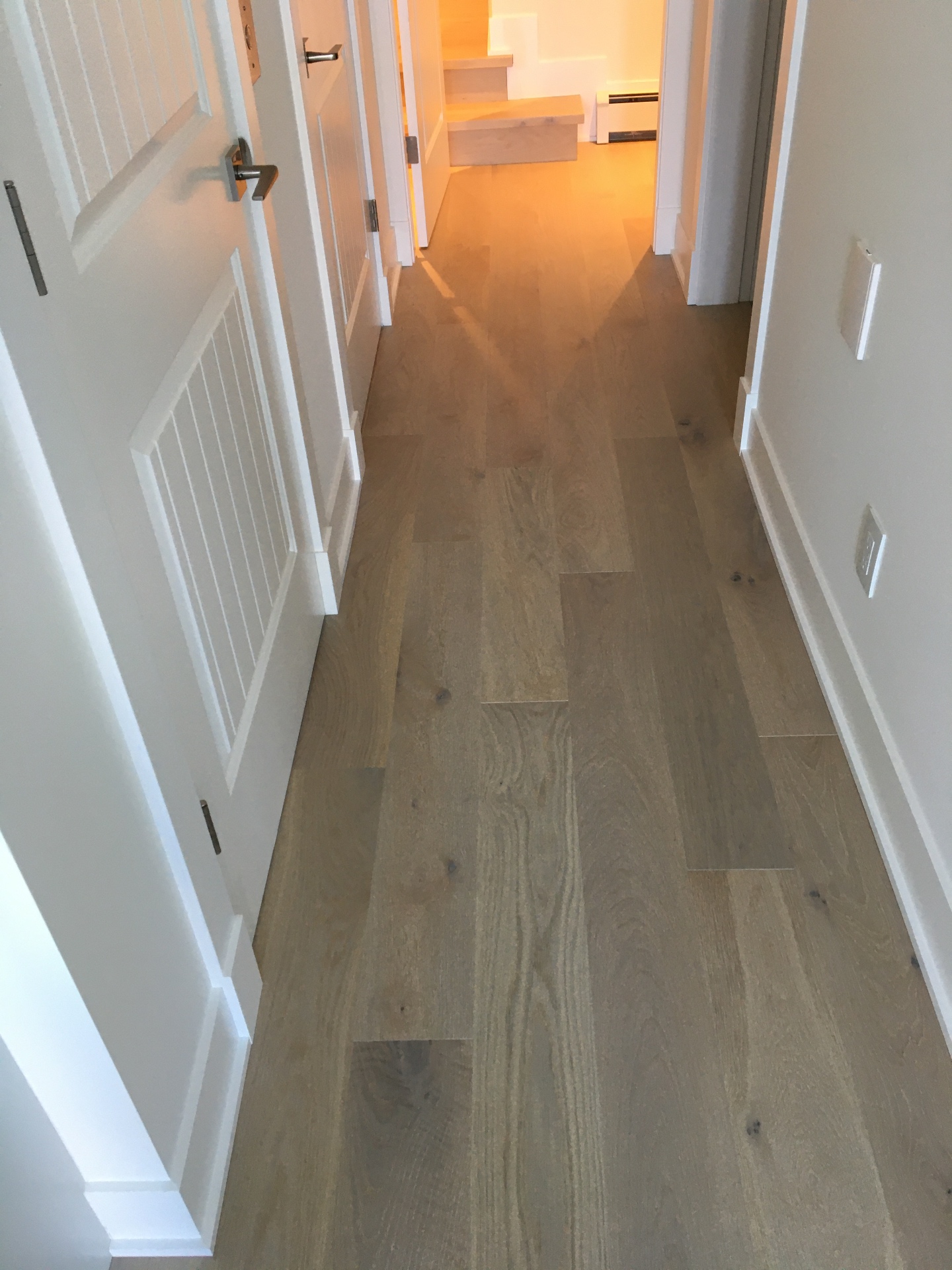 Point Grey Rd Vancouver Home — Mirage white oak hardwood hallway leading to bedrooms