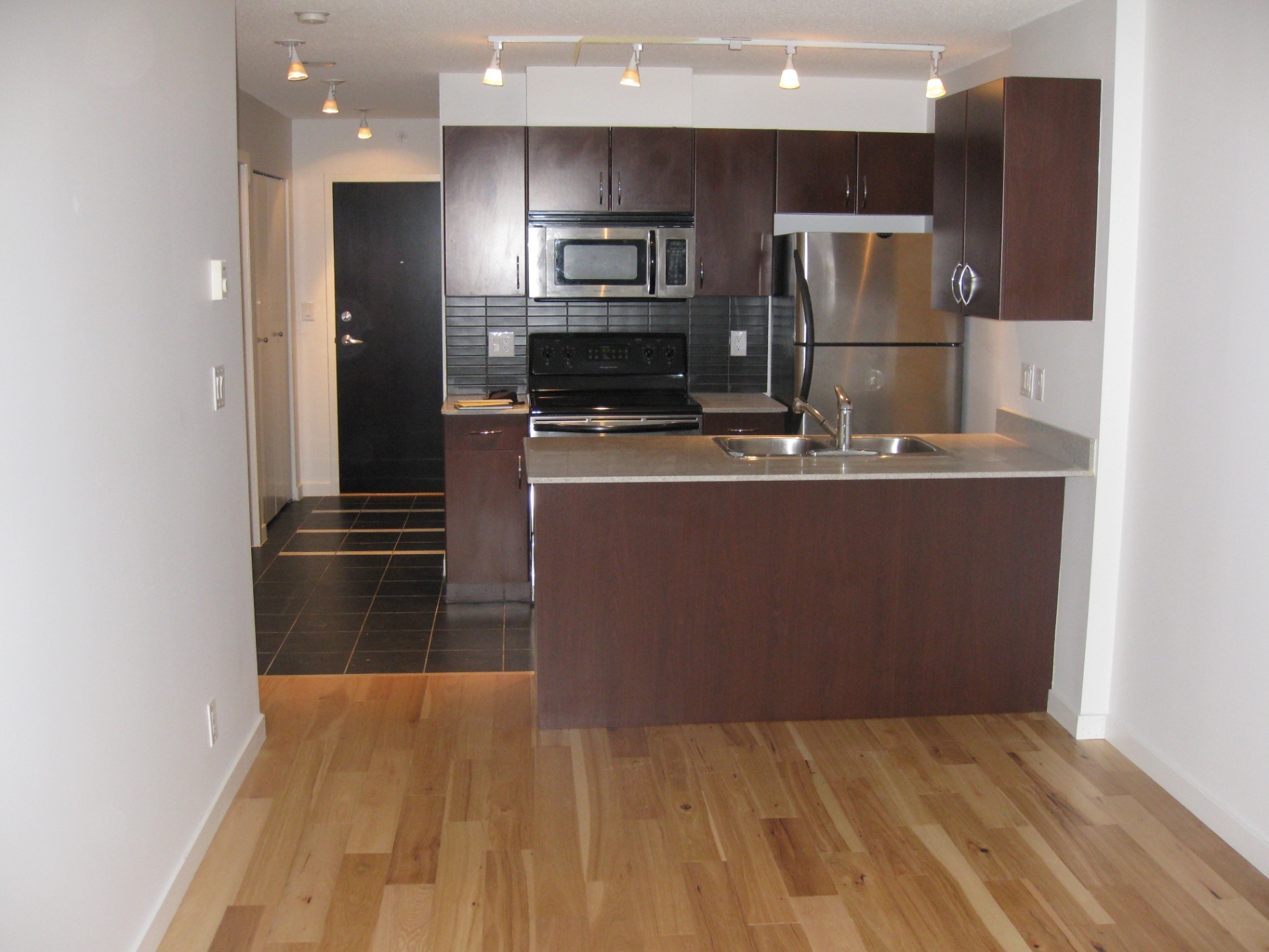 Downtown Vancouver Condo — natural hickory hardwood in open-concept kitchen and living area