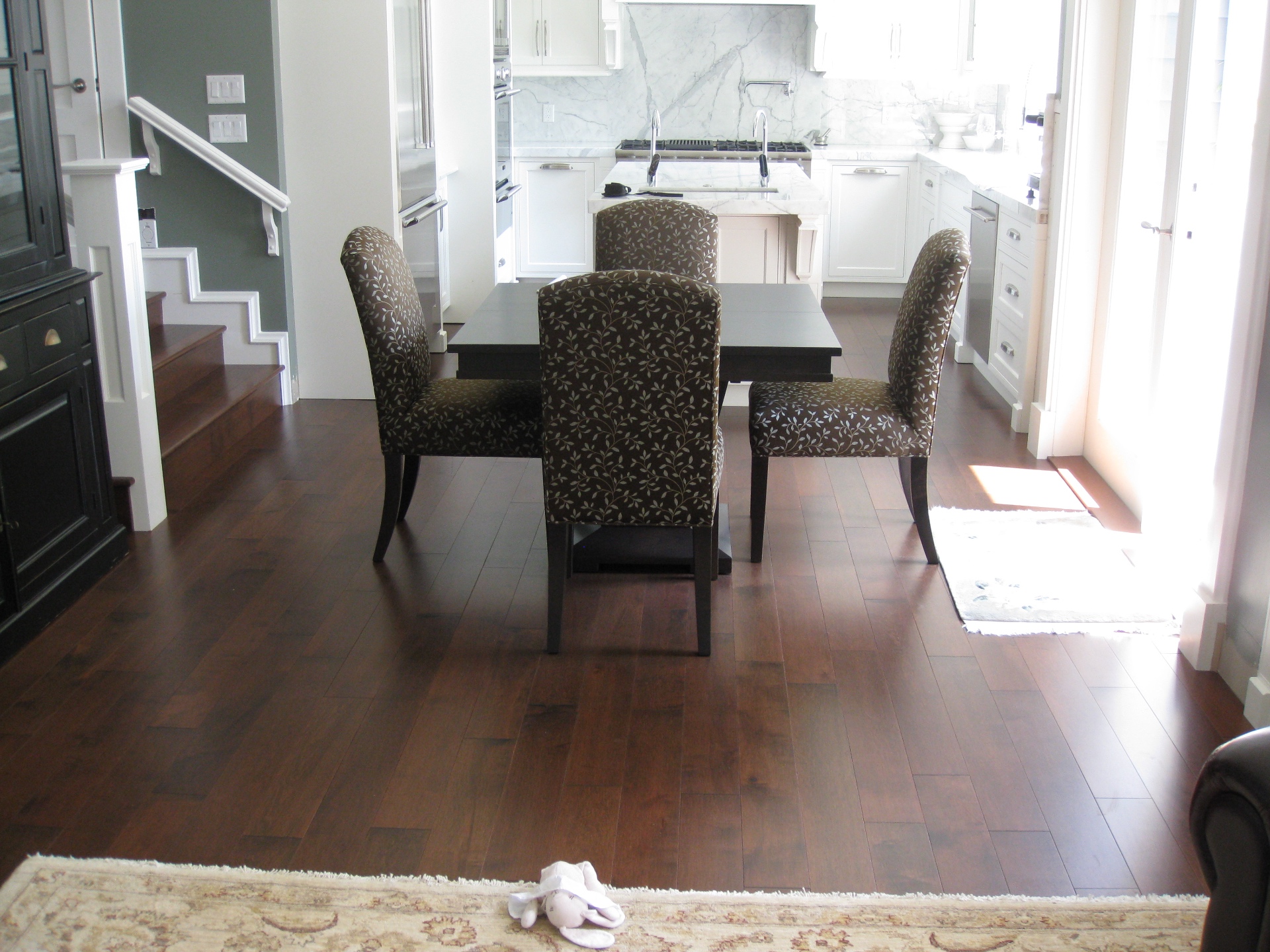 North Vancouver House — dark maple hardwood in dining area opening to marble kitchen