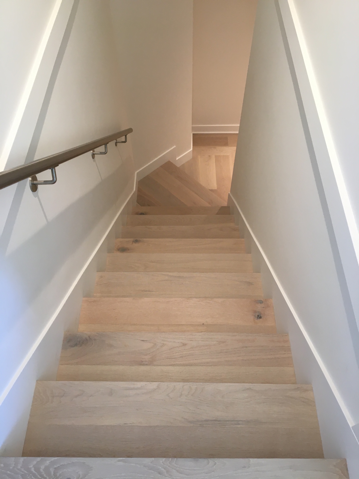 Point Grey Rd Vancouver Home — white oak staircase descending with metal handrail