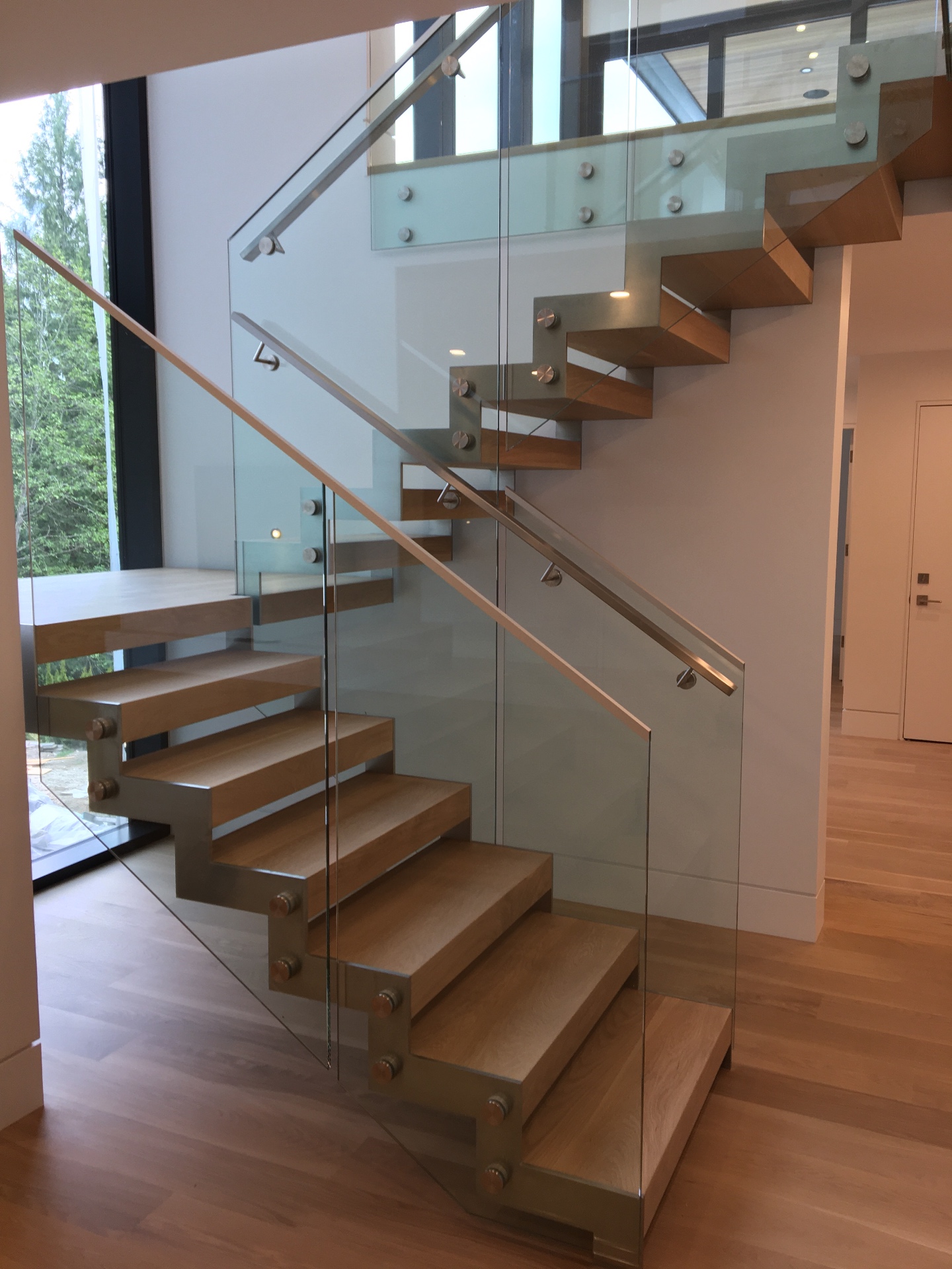 West Vancouver Home — custom floating white oak staircase with glass railings and stainless handrail