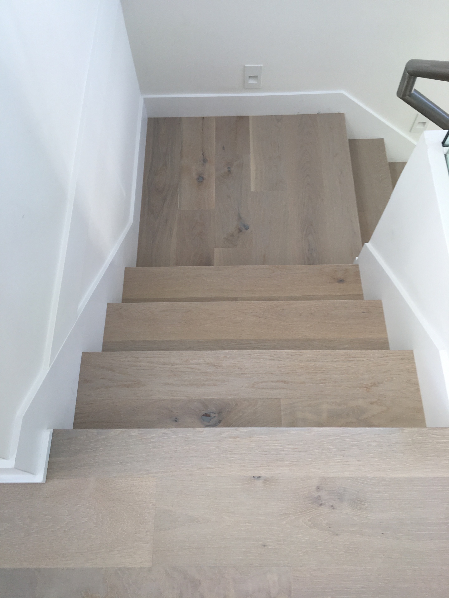 Point Grey Rd Vancouver Home — overhead view of white oak stair treads and landing