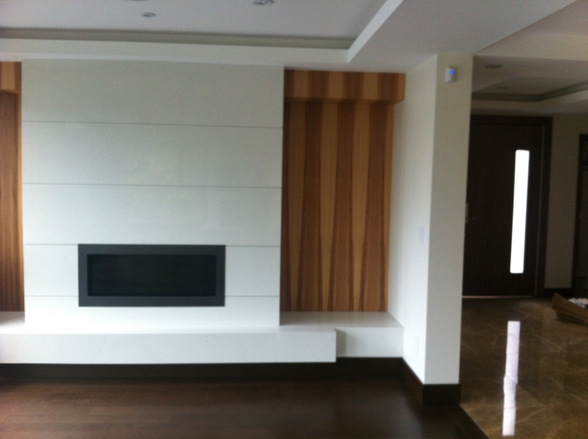 West Vancouver Home — Vintage walnut hardwood with white shiplap fireplace wall and teak panel accent