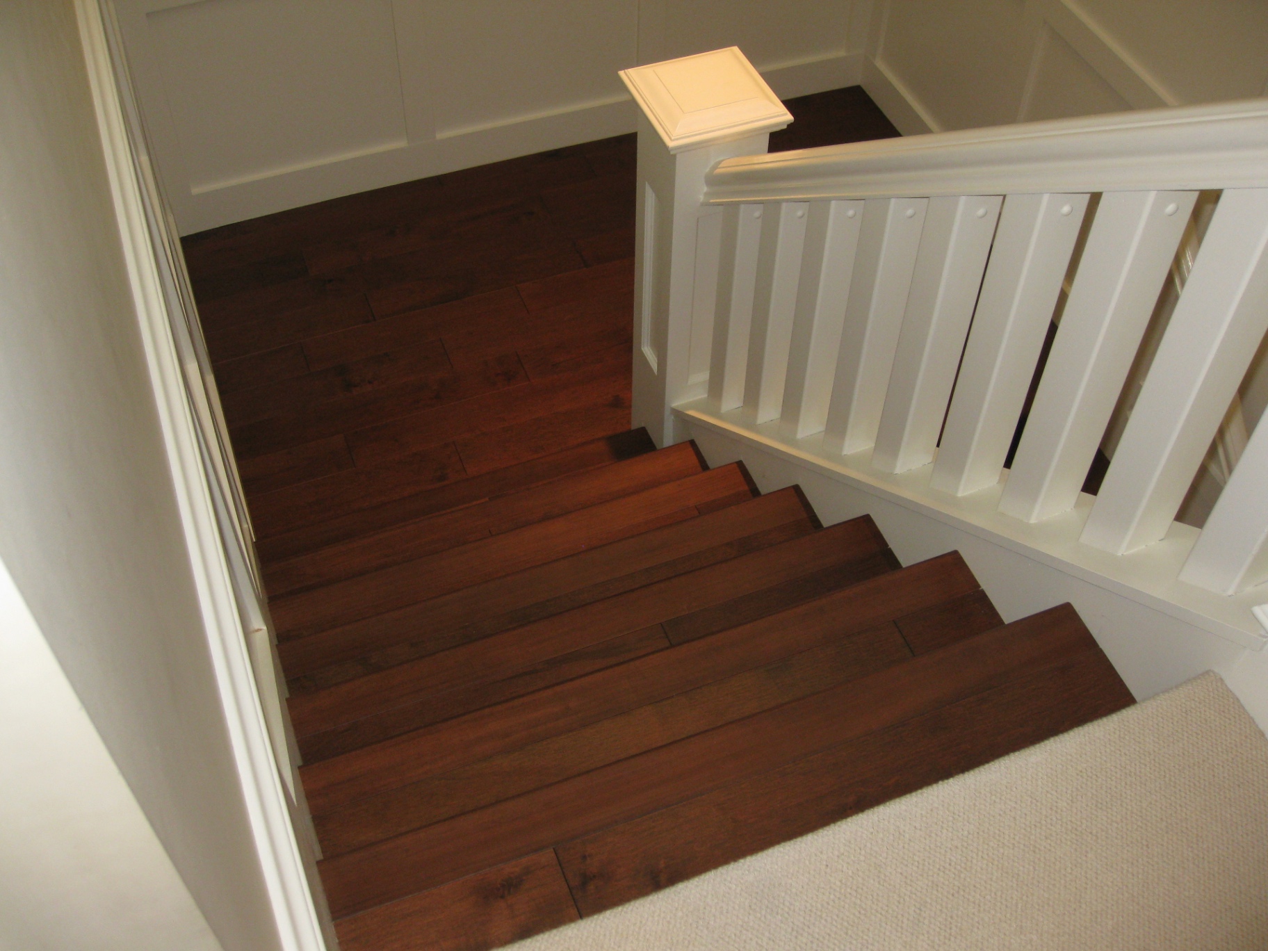 North Vancouver House — dark maple staircase with white board-and-batten panelling