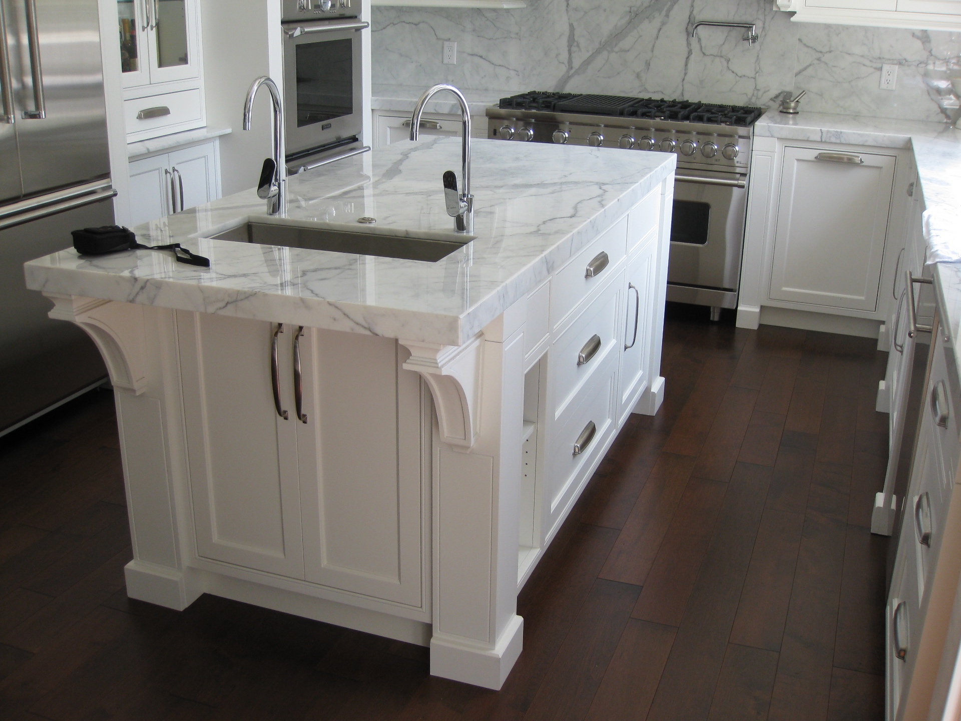 North Vancouver House — dark hardwood floor in marble kitchen with custom island