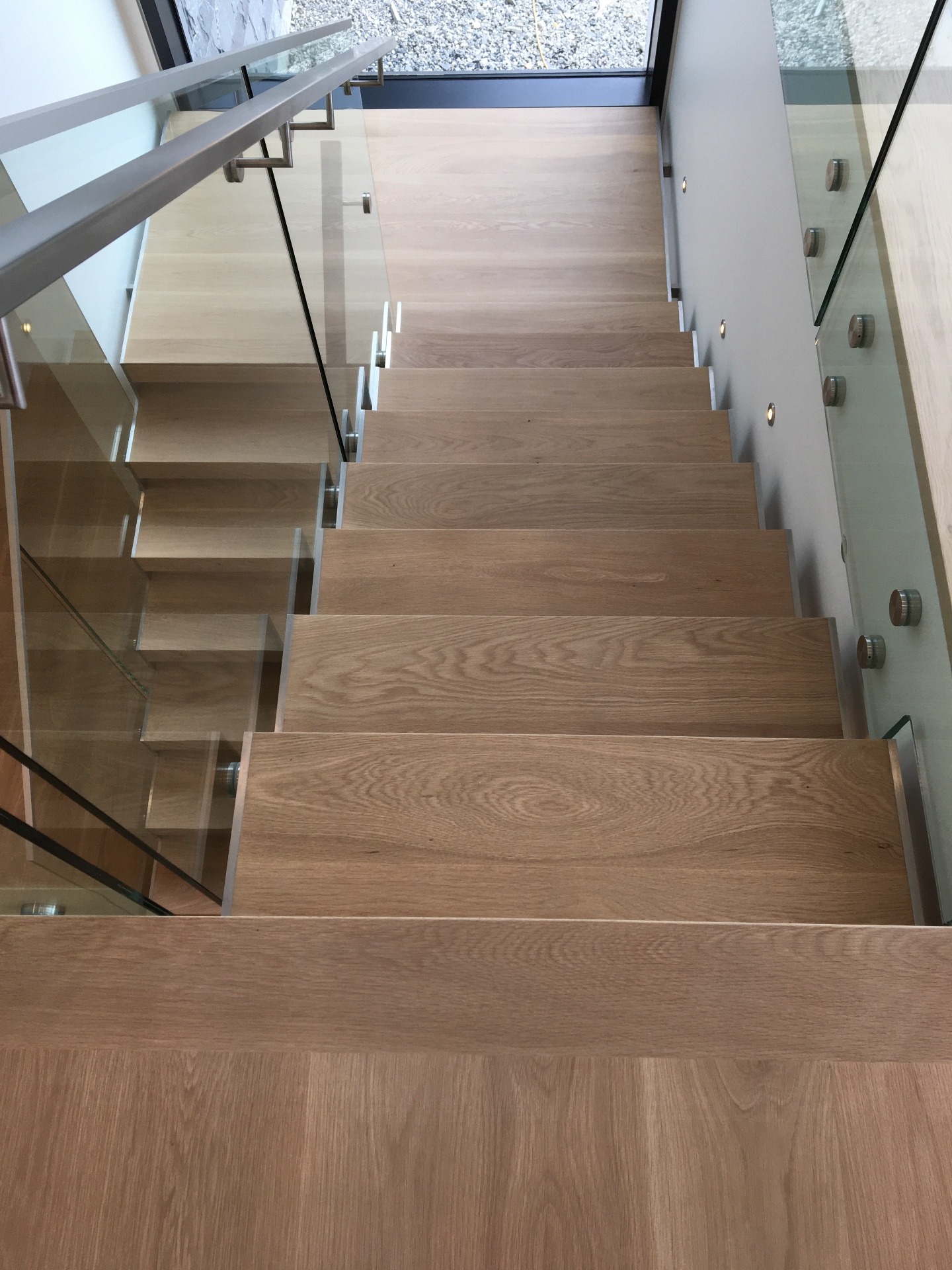 West Vancouver Home — overhead view of floating white oak stair treads with Loba Invisible finish